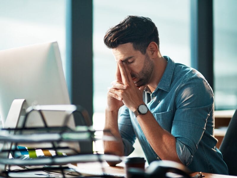 man with his hands on his face, showing regret